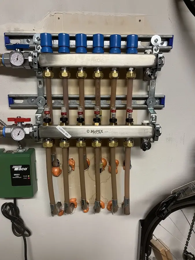 Plumber performing Water Heater Repair at a residential property in Au Sable